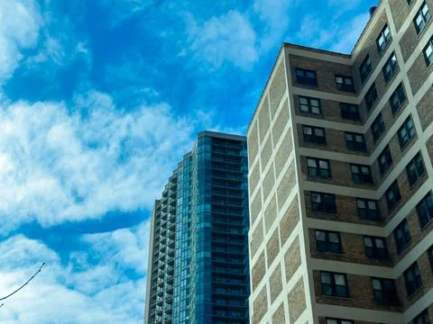 Clouds float over buildings in an urban area on a sunny day in the city, hi.. 写真素材