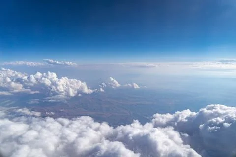 Clouds Float Over City Under A Blue Sky Stock Photos