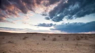 Clouds Float Over The Desert At Sunset. Stock Footage