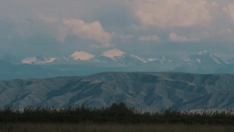 Clouds float over mountain peaks Stock-Footage 245784355