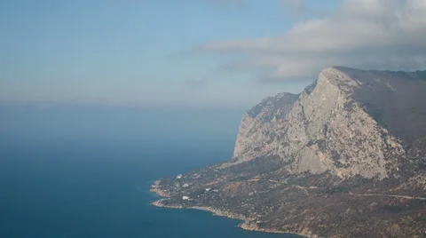 Clouds float over the sea and the mountains. Timelapse. Video stock 46792981