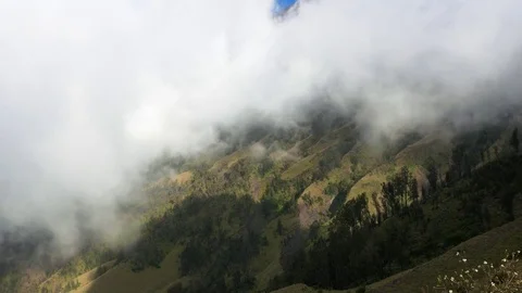 Clouds float over valley forest on Mount Rinjani Lombok Indonesia July 2017 Video stock 83894083
