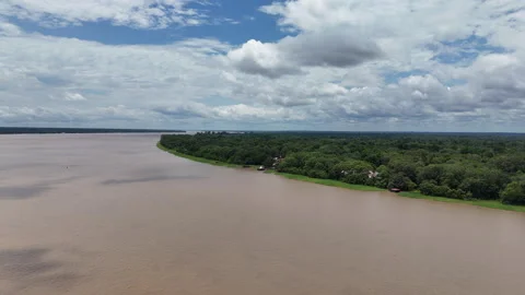 Clouds float over a wide bend of the river and a dense forest in the Amazon. Stock Footage 334636699