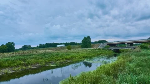 Clouds float quickly across the sky. The highway passes over the bridge. A sm Stock Footage 161981852