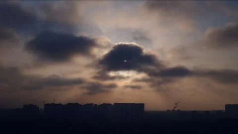 The clouds float quickly over the city, the sun breaks through the clouds Stockbeeldmateriaal 267094039