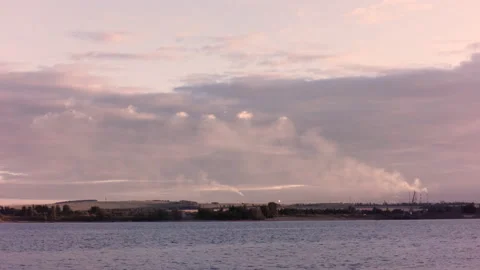 Clouds float in the sky. Smoke comes from the chimneys of the plant. Ships sail Stock Footage 142081822