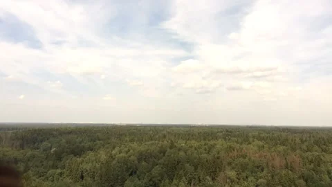 Clouds floating above a green forest time lapse Видео 136658668