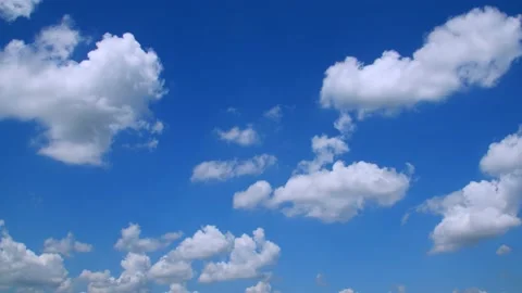 Clouds floating along in a blue sky on a spring day. 4k60p Stock Footage 132221392