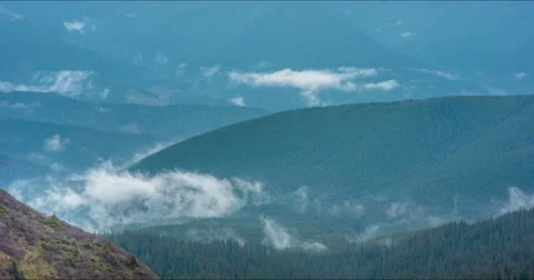 Clouds floating in high mountains Stock Footage 57950436