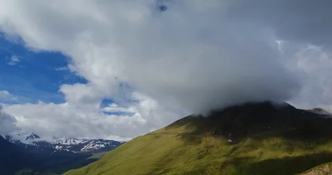 Clouds floating low over mountain meadows and lush spring alpine grass Stock Footage 104860826