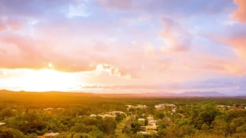 Clouds floating over green forest and houses Stock Footage 76105876