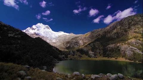 Clouds floating over green lake and mountain Stock Footage 77444916