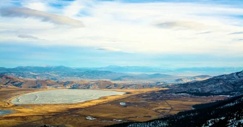 Clouds floating over hot water spring and mountainous landscape Stock Footage 77766166