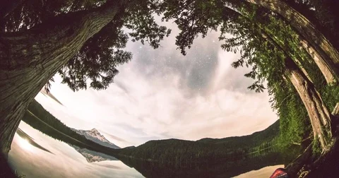 Clouds floating over the lake and trees Stock Footage 77768579