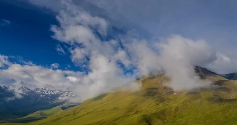Clouds floating over mountain meadows and lush spring alpine grass 動画素材 105011997