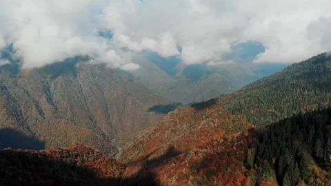 Clouds floating over mountain ridges with autumn vegetation. Dynamic weather in Stock Footage 324959134