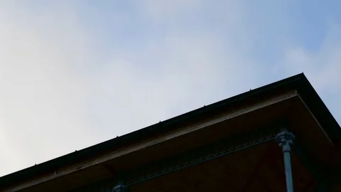 Clouds floating over the roof edge. Stock-Footage 76562194