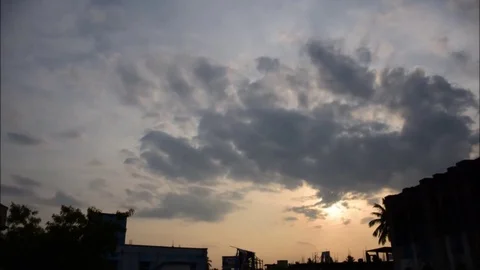 Clouds floating over setting sun time lapse Stock Footage 80552425