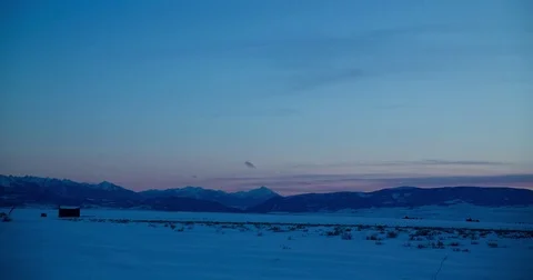 Clouds floating over snow covered mountains and landscape Video stock 83885844