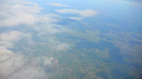 Clouds floating over a vast blue sky, captured from a high altitude in 4K s.. Stock Footage 290099288