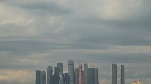 Clouds floating in the sky and the tops of skyscrapers of the Moscow City Stock Footage 214053162
