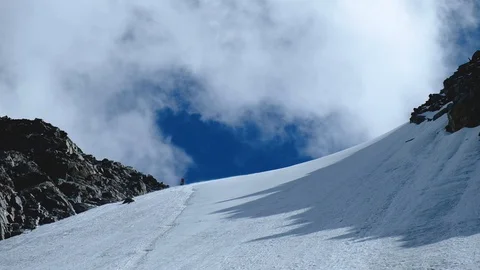 Clouds floating in sky in mountains. Climber silhouette on sky background 스톡 동영상 128280960