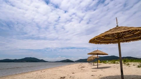 Clouds flow over the beach beach umbrella Stock Footage 145890408