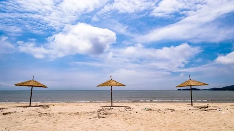 Clouds flow over the beach beach umbrella 스톡 동영상 145890418