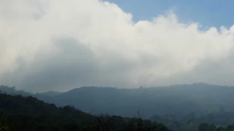 Clouds flow over hills time lapse Stock Footage 6532369