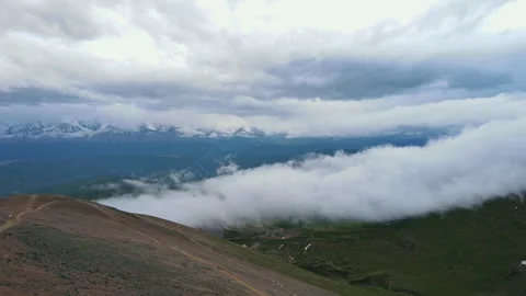 Clouds flowing between the hills . Drone shoot. 4k Stock Footage 254435982