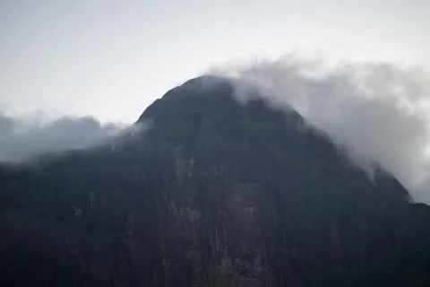 Clouds flowing down the hilly mountains Stock Photos