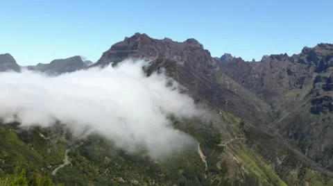 Clouds flowing over a mountain Stock Footage 10573468