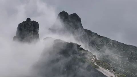 Clouds flowing over mountain peaks Stock Footage 300938448