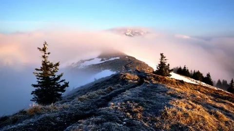 Clouds flowing over a mountain ridge and a mountain peak in a national park in Stock Footage 238625849