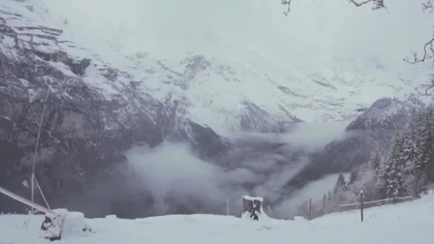 Clouds flowing over snowy mountains in the alps Stock-Footage 289663328