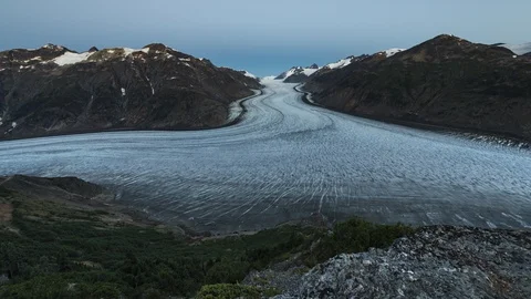 Clouds flowing over valley with receding glacier and lush green forest 8K time Stock Footage 114016766