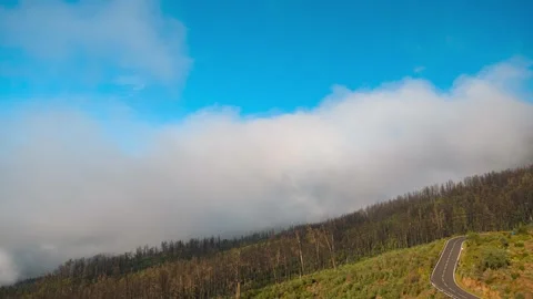 Clouds Flowing Over Winding Mountain Road with Cars Tenerife 4K Timelapse Stock-Footage 334397039