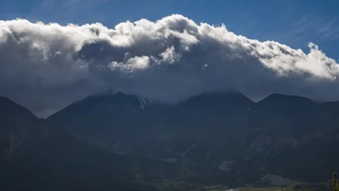 Clouds flowing over Yukon mountain range 8K time lapse Stock Footage 111359446