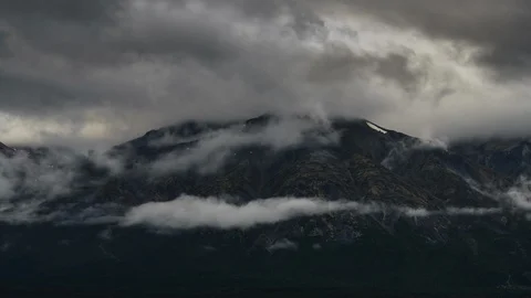 Clouds flowing over Yukon mountain range 8K time lapse Stock Footage 112480497