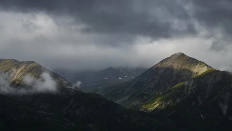 Clouds flowing over Yukon mountain range 8K time lapse Stock Footage 112480726