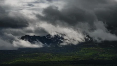 Clouds flowing over Yukon mountain range 8K time lapse Stock Footage 112482384