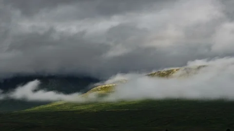 Clouds flowing over Yukon mountain range 8K time lapse Stock Footage 112484197
