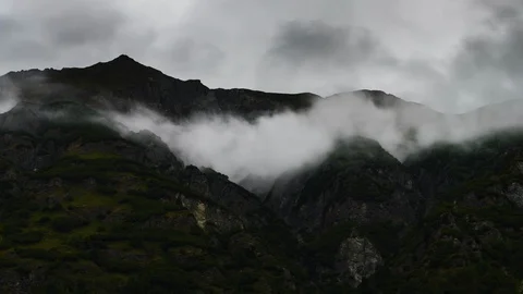 Clouds flowing over Yukon mountain range 8K time lapse Stock Footage 112486635