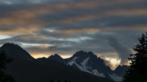 Clouds flowing over Yukon mountain range at sunset 8K time lapse Stock Footage 112492538
