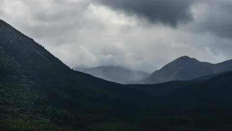 Clouds flowing over Yukon mountain range 8K time lapse Stock Footage 113973565