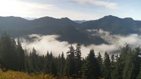 Clouds flowing through valley 4 Stock Footage 101201206