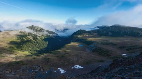 Clouds flowing through a valley near Mt. Rainier Stock-Footage 69042434