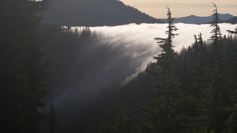 Clouds flowing into valley 2 Stock Footage 101197686