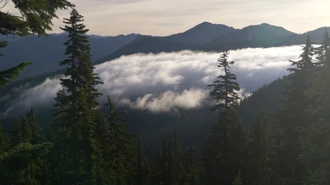 Clouds flowing into valley 3 Stock Footage 101195817
