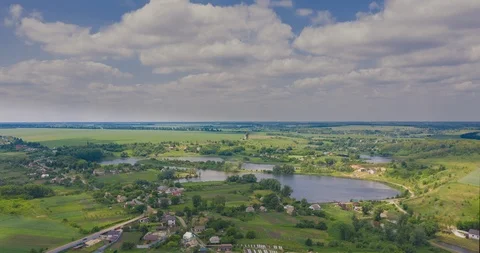 Clouds fly fast over a winding Amazing  lake and green forests on a sunny summer Stock Footage 112701136